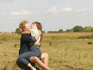 Beautiful Teen Couple in Love Passionately Kissing on the field