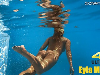 Eyla Moore, a famous model, glides elegantly through the water